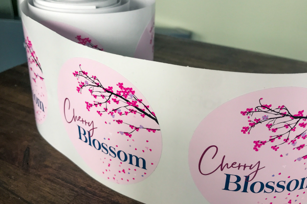 Circle pink, purple and blue labels on a roll