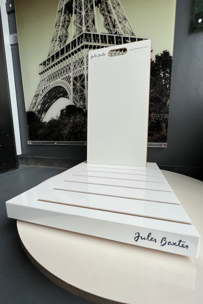 White tile display stand with blue logo
