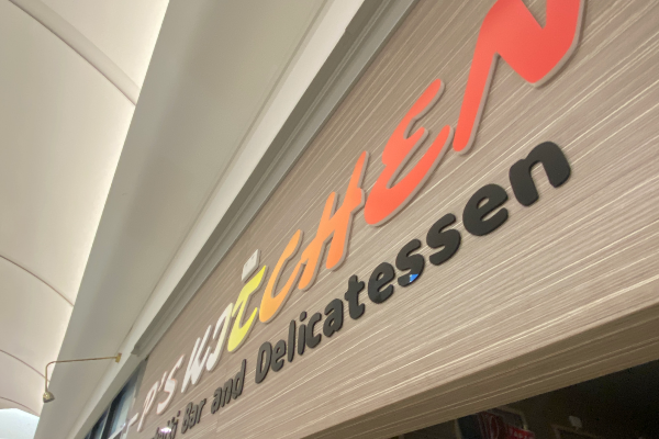 3D acrylic lettering installed on front of cafe overhead with gradient colour