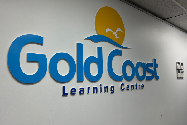 Cutout Acrylic Logo with blue and yellow vinyl, installed on reception wall