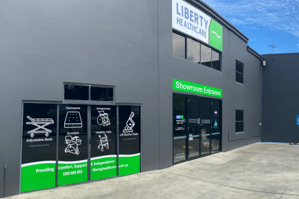 image of grey building with white, green and blue signage and window decals