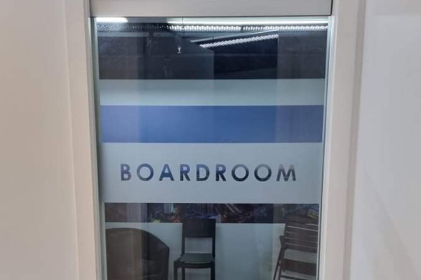 silver etch privacy vinyl strip on small glass door with word 'boardroom' cut out
