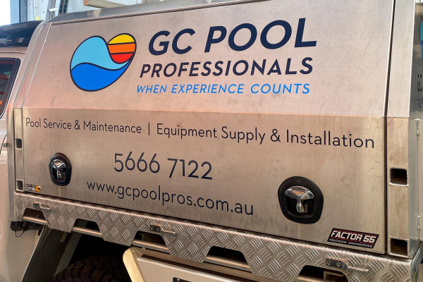 Cutout vinyl logo and text installed onto the back of a stainless steel ute canopy and side