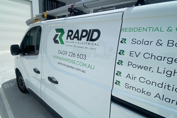 Black and Green logo and text cut out vinyl applied to side of white van