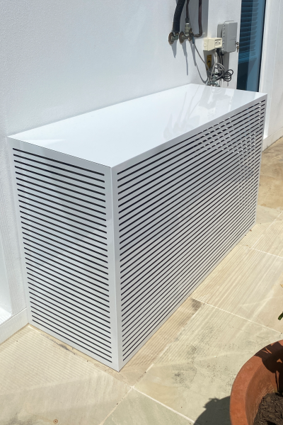White air conditioner cover box sitting in front of white external wall