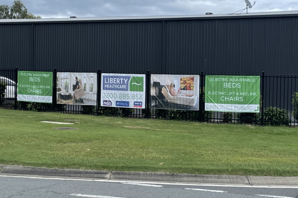 image of external pole fence with PVC mesh banners installed to them