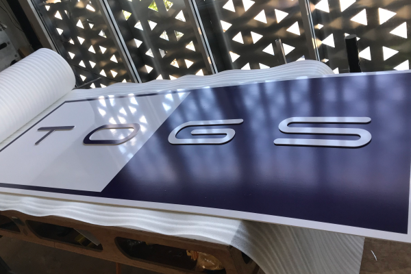 image of a blue and white sign ready to be packed for dispatch
