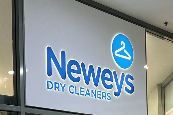 an ACM lightbox with glowing logo installed to face of shopfront