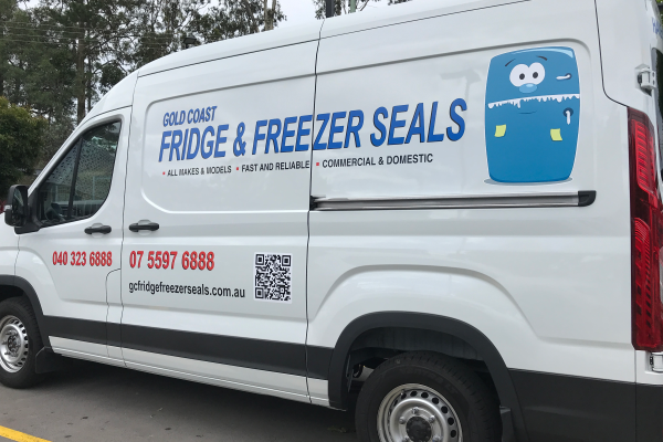 image of white van with logo and contact decals on the side