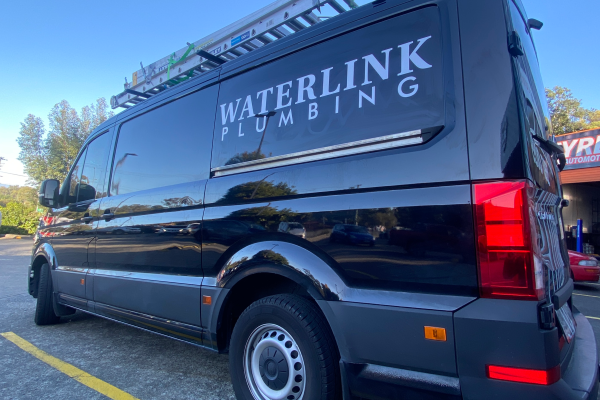 image of black van with white logo and contact decals applied to the side