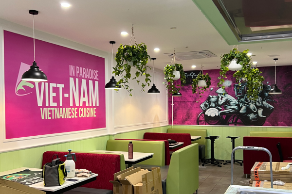 pink wall paper installed to internal walls inside a restaurant