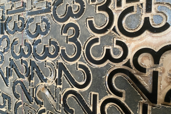 Cut out numbers of 2 and 3 from black acrylic