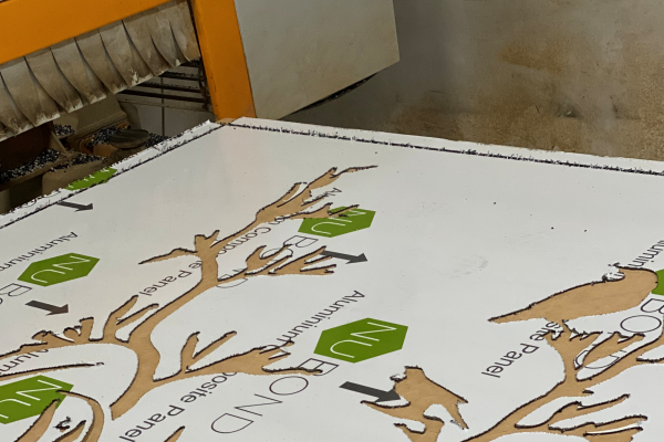 ACM sheet coming out of CNC router