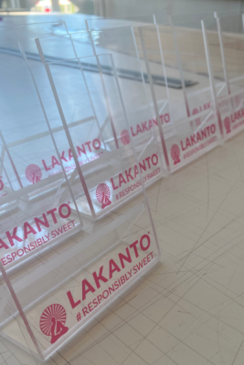 image of clear acrylic product stands sitting in a row on a desk