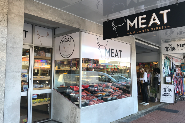 shopfront with hanging sign and window decals