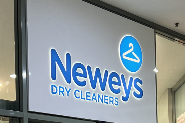 illuminated business signage with white background and halo lit lettering