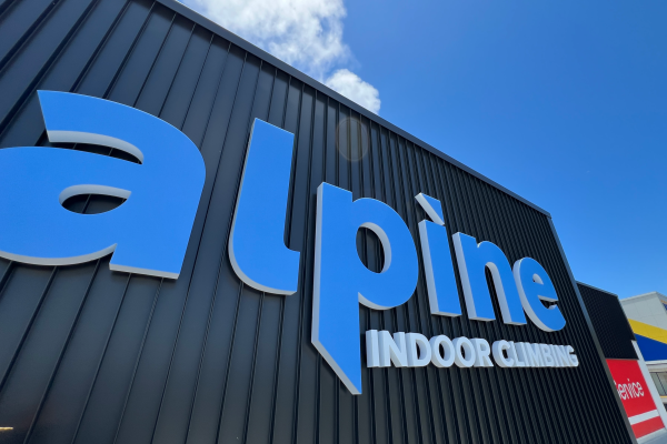 Large 3D illuminated fabricated letters signage installed on top of building facade